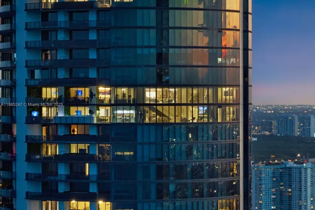 a dining room with furniture and a floor to ceiling window