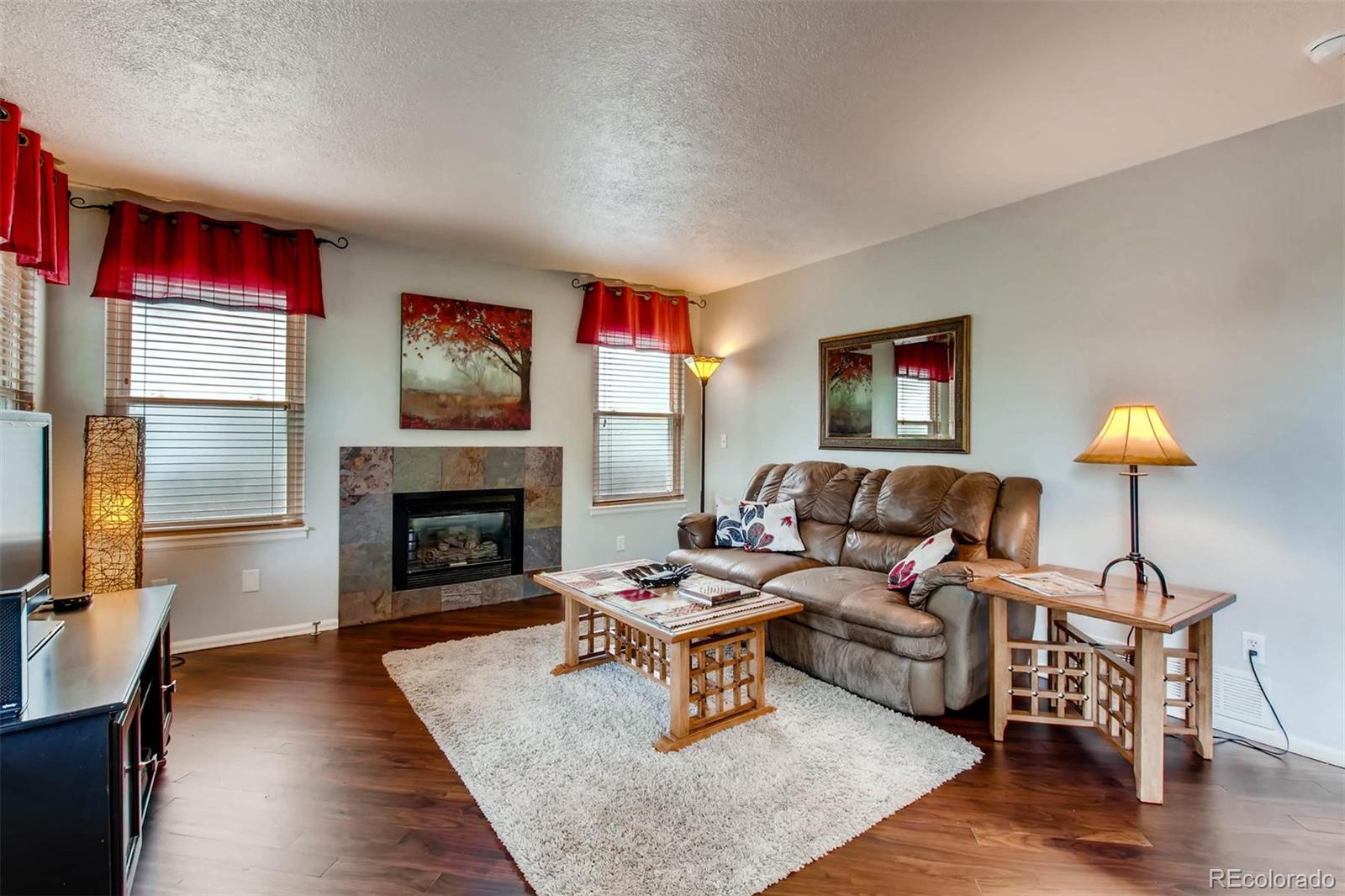 13360 Cherry Circle Thornton, CO 80241 - Photo 13 of 26 a living room with furniture and a fireplace