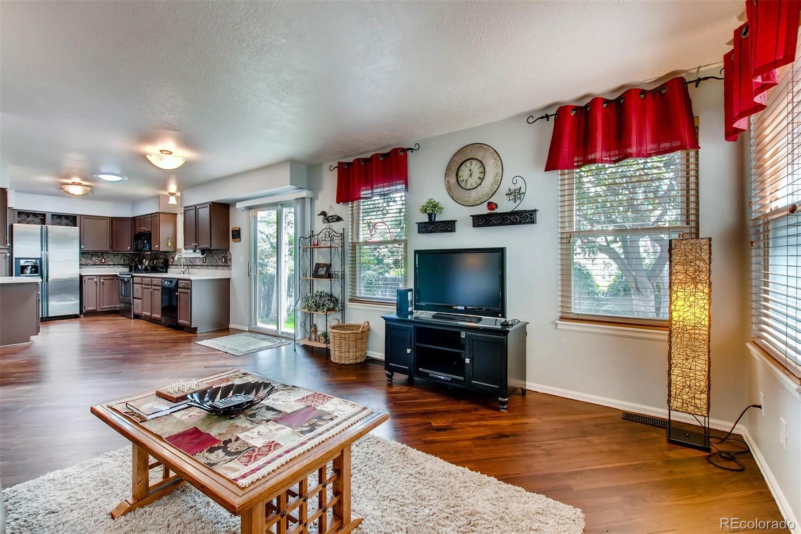 13360 Cherry Circle Thornton, CO 80241 - Photo 14 of 26 a living room with furniture and a flat screen tv