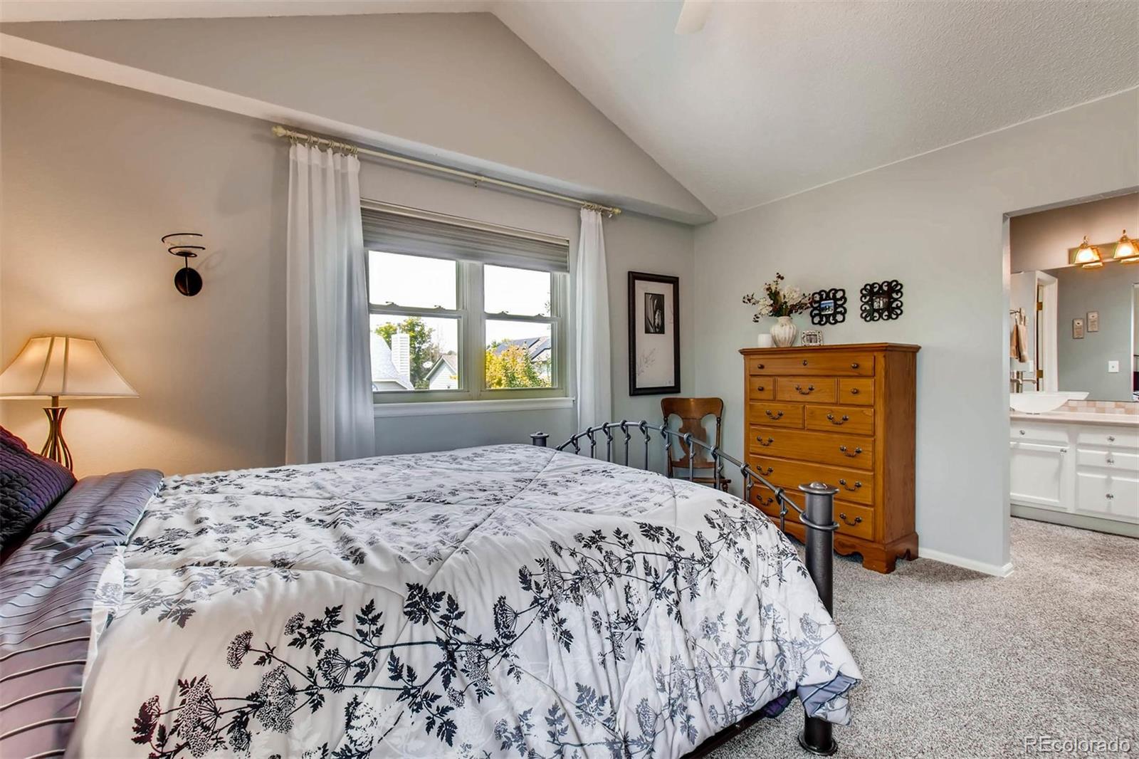 13360 Cherry Circle Thornton, CO 80241 - Photo 17 of 26 a bedroom with a bed and a dresser