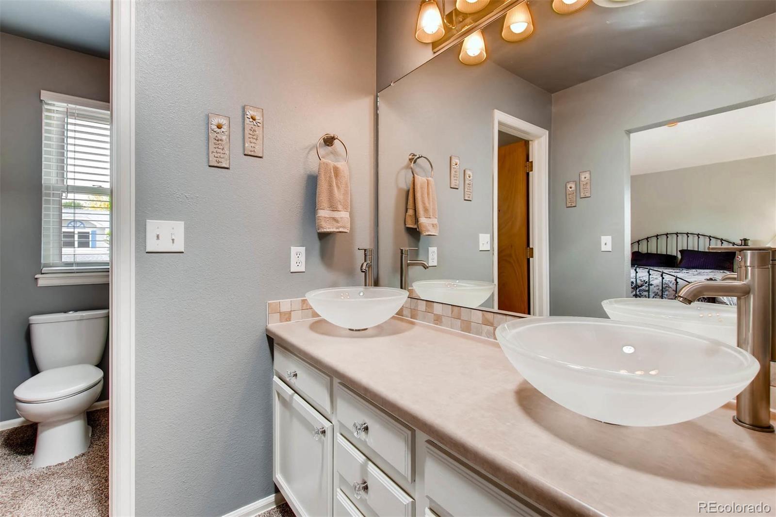 13360 Cherry Circle Thornton, CO 80241 - Photo 18 of 26 a bathroom with a sink and a mirror
