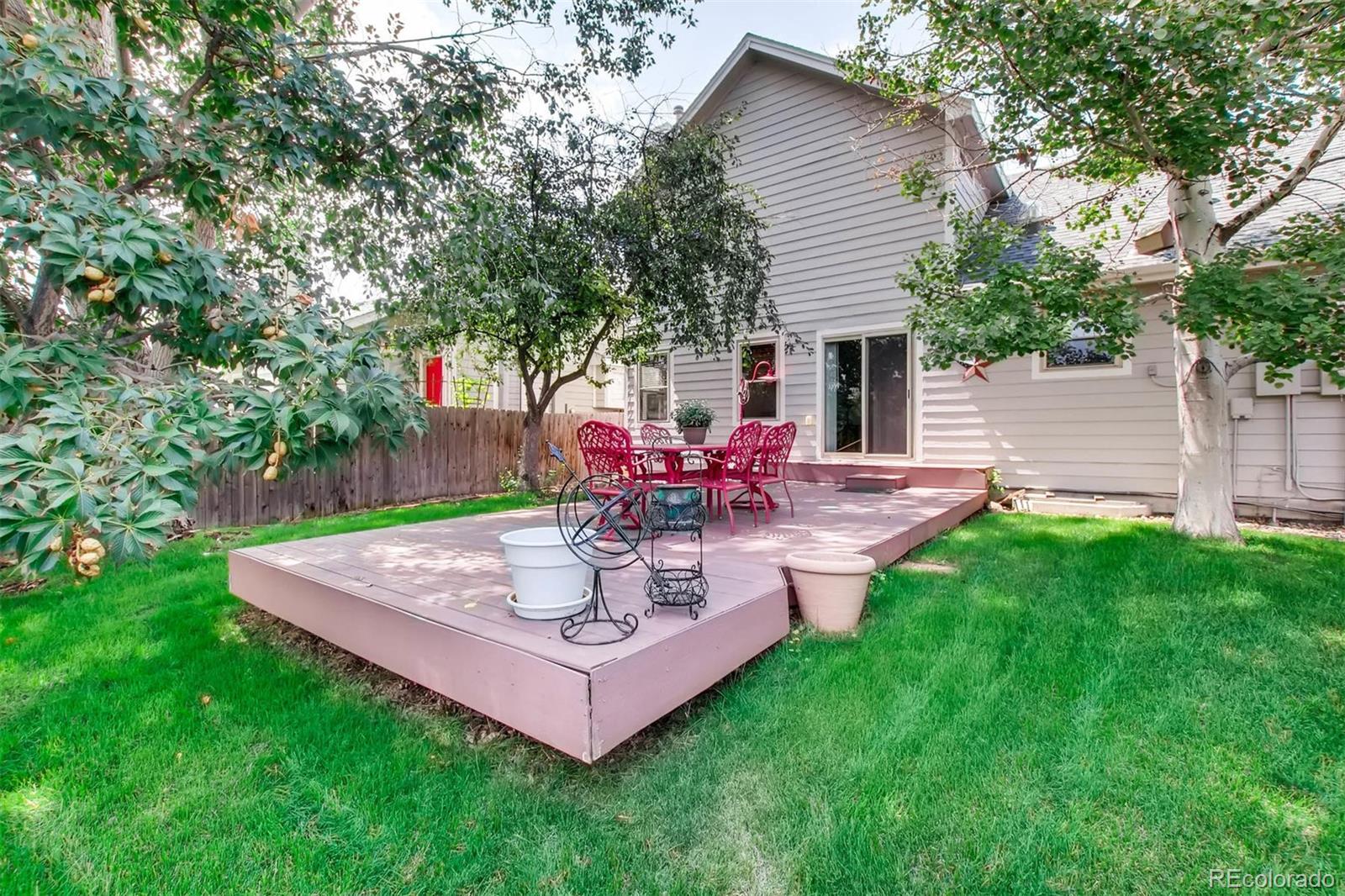 13360 Cherry Circle Thornton, CO 80241 - Photo 25 of 26 a view of a backyard with table and chairs potted plants and large tree