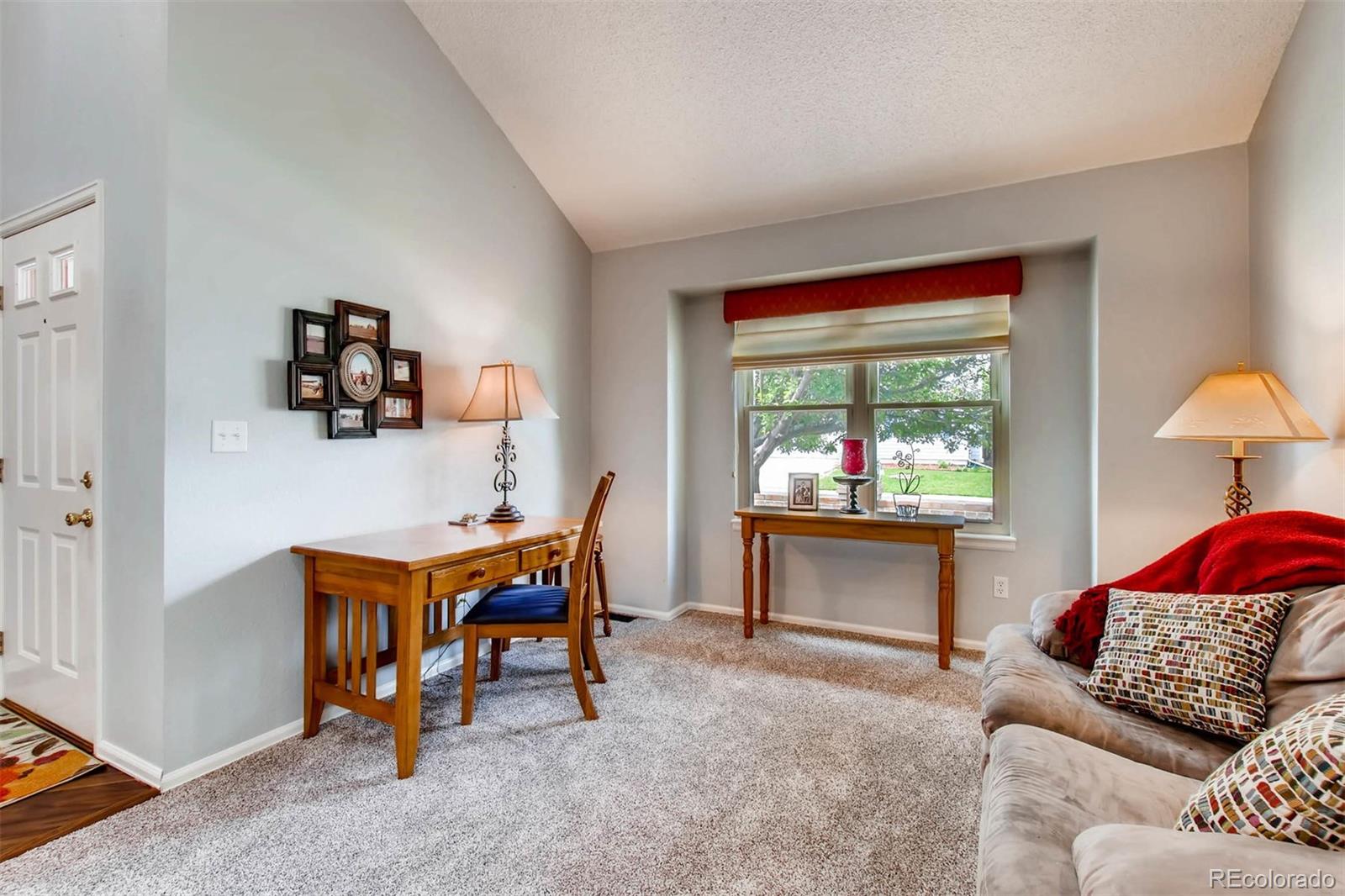 13360 Cherry Circle Thornton, CO 80241 - Photo 6 of 26 a living room with furniture and a window