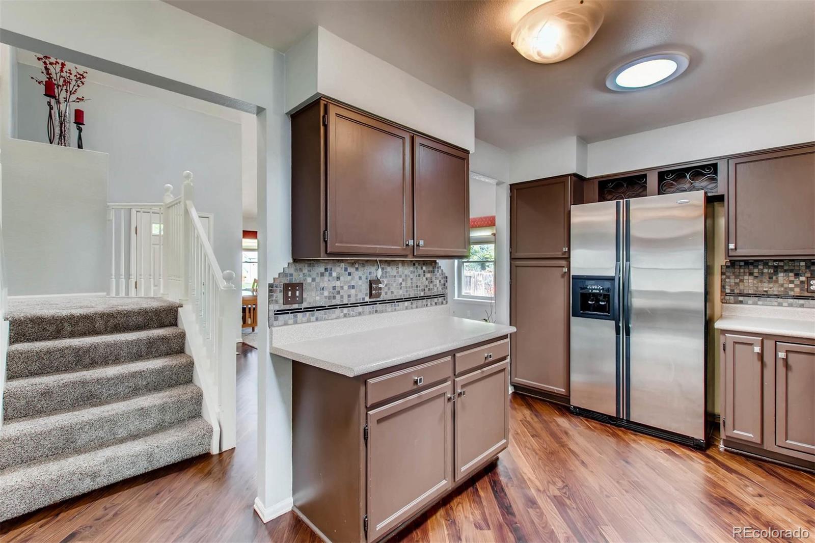 13360 Cherry Circle Thornton, CO 80241 - Photo 9 of 26 a kitchen with stainless steel appliances a sink and a refrigerator