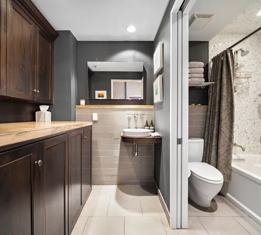 a bathroom with a sink toilet and shower