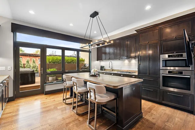 a kitchen with kitchen island a large counter top space appliances and cabinets