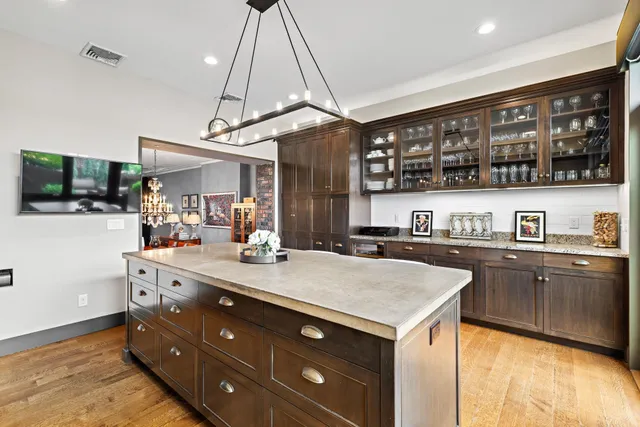 a kitchen with a sink a counter space appliances and cabinets