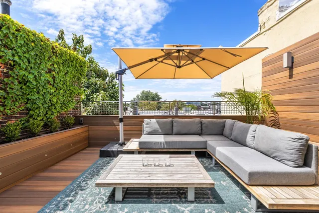 a living room with furniture a flat screen tv and a floor to ceiling window