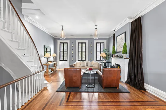 a living room with furniture windows and wooden floor