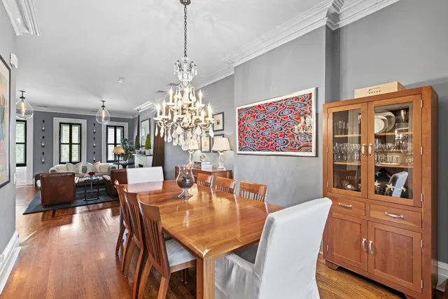 a view of a dining room with furniture wooden floor and chandelier