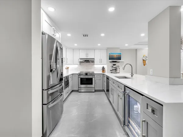 a kitchen with stainless steel appliances granite countertop a stove and a sink