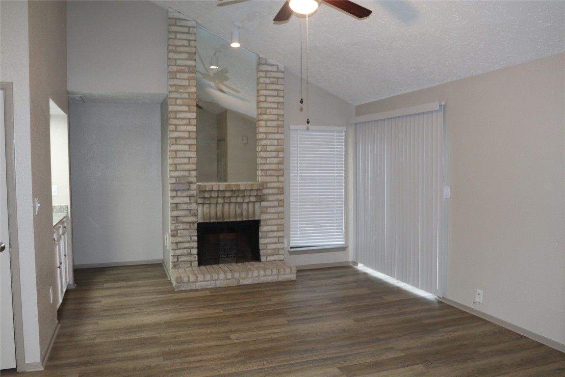 11530 Ridge Run Drive Houston, TX 77064 - Photo 14 of 38 a view of an empty room with wooden floor fireplace and a window