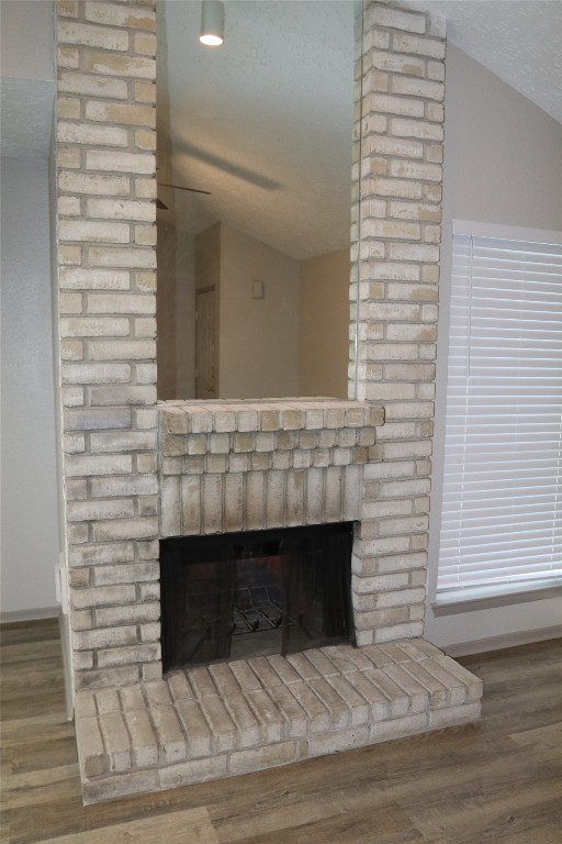 11530 Ridge Run Drive Houston, TX 77064 - Photo 16 of 38 a living room with a fireplace and a wooden floor