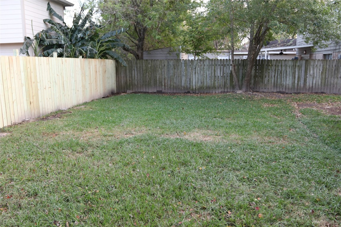 11530 Ridge Run Drive Houston, TX 77064 - Photo 35 of 38 a view of a backyard with a small cabin and a large tree