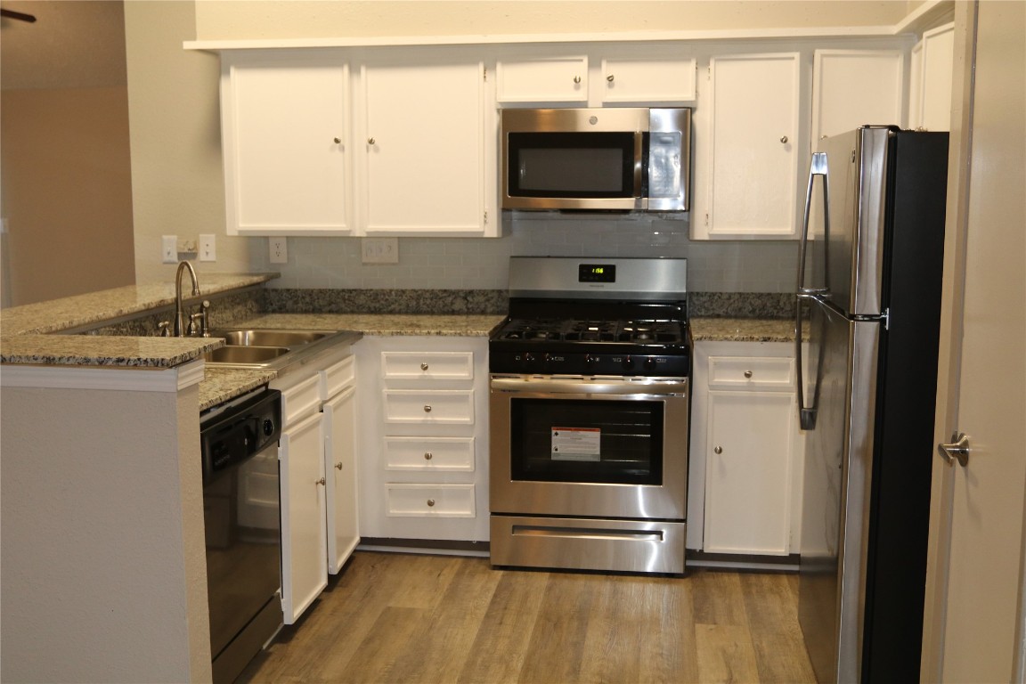 11530 Ridge Run Drive Houston, TX 77064 - Photo 5 of 38 a kitchen with stainless steel appliances a stove microwave and a refrigerator