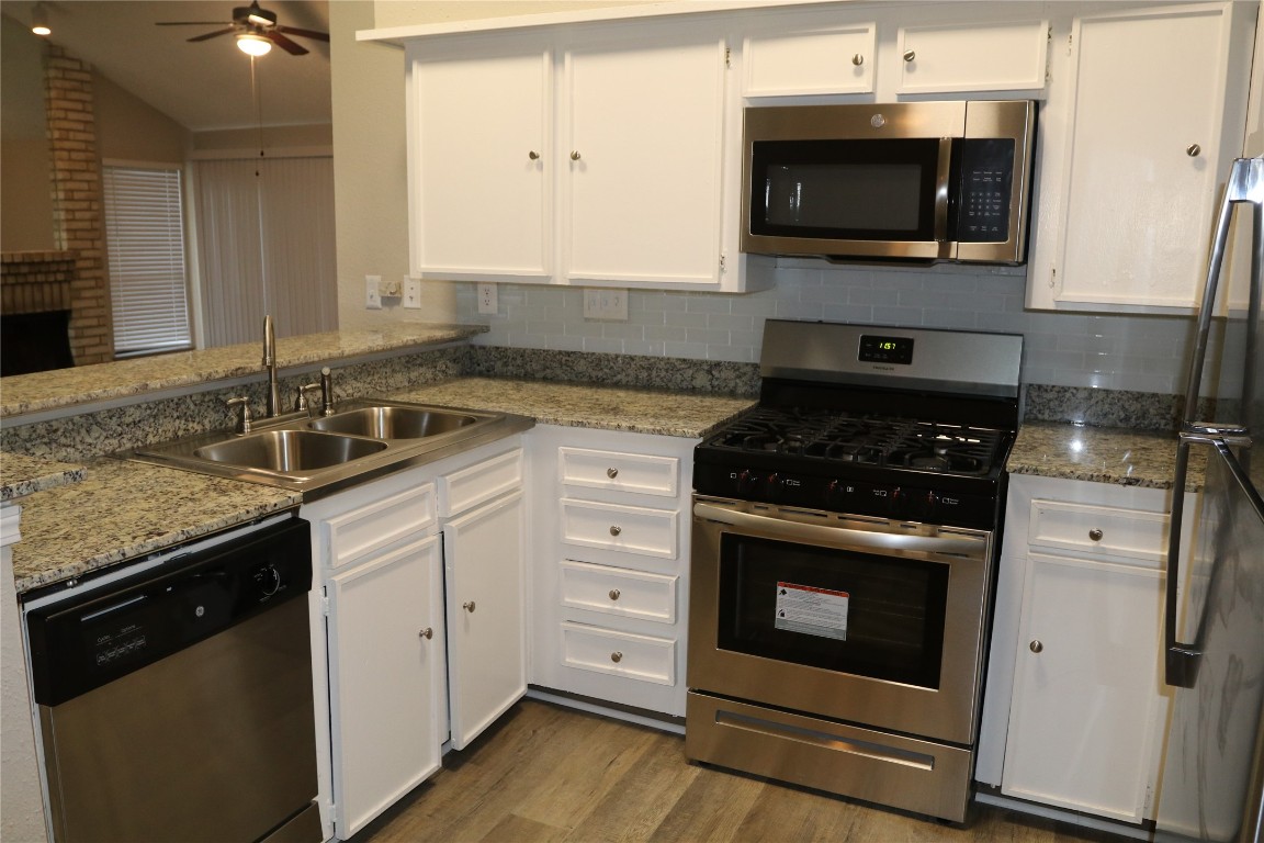 11530 Ridge Run Drive Houston, TX 77064 - Photo 8 of 38 a kitchen with stainless steel appliances granite countertop a stove and a microwave