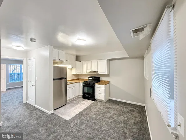 a kitchen with a refrigerator and a sink