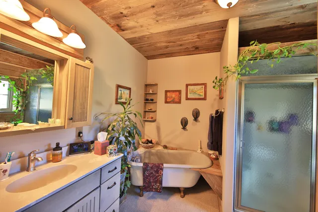 a bathroom with a sink and mirror with toilet
