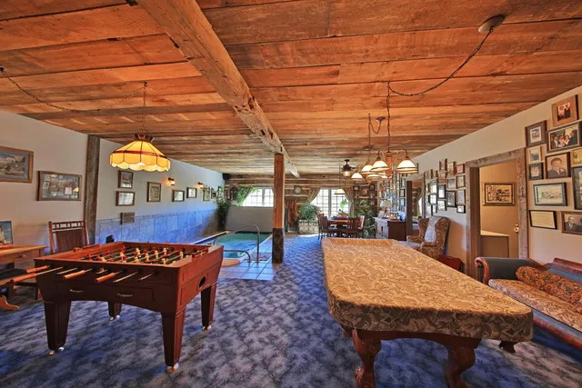 a dining room with a wooden table and chairs