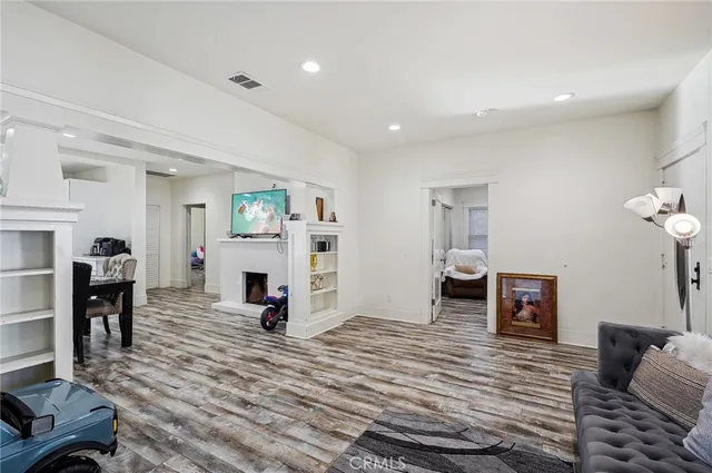 a kitchen with stainless steel appliances kitchen island granite countertop a sink and a refrigerator