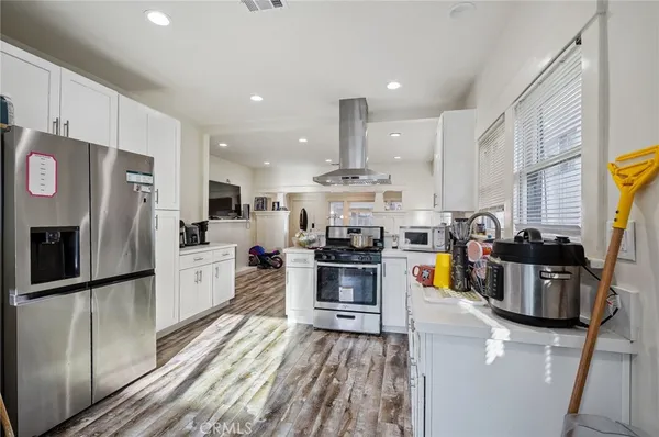 a kitchen with stainless steel appliances a sink stove and cabinets