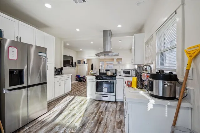a kitchen with stainless steel appliances a sink stove and cabinets
