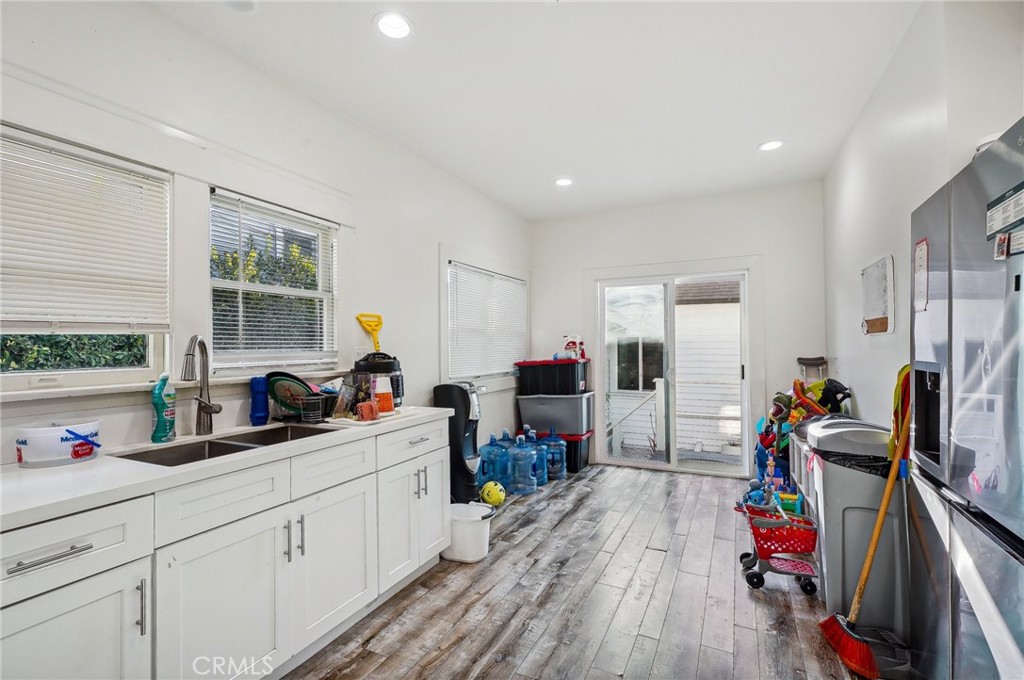 7251 Painter Avenue, Unit 7255 Whittier, CA 90602 - Photo 19 of 56 a very nice looking living room with a large window and wooden floors