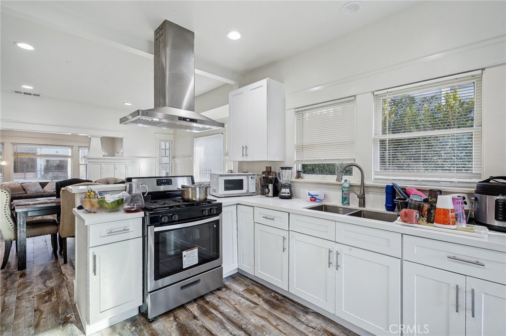7251 Painter Avenue, Unit 7255 Whittier, CA 90602 - Photo 20 of 56 a kitchen with stainless steel appliances a sink stove and cabinets