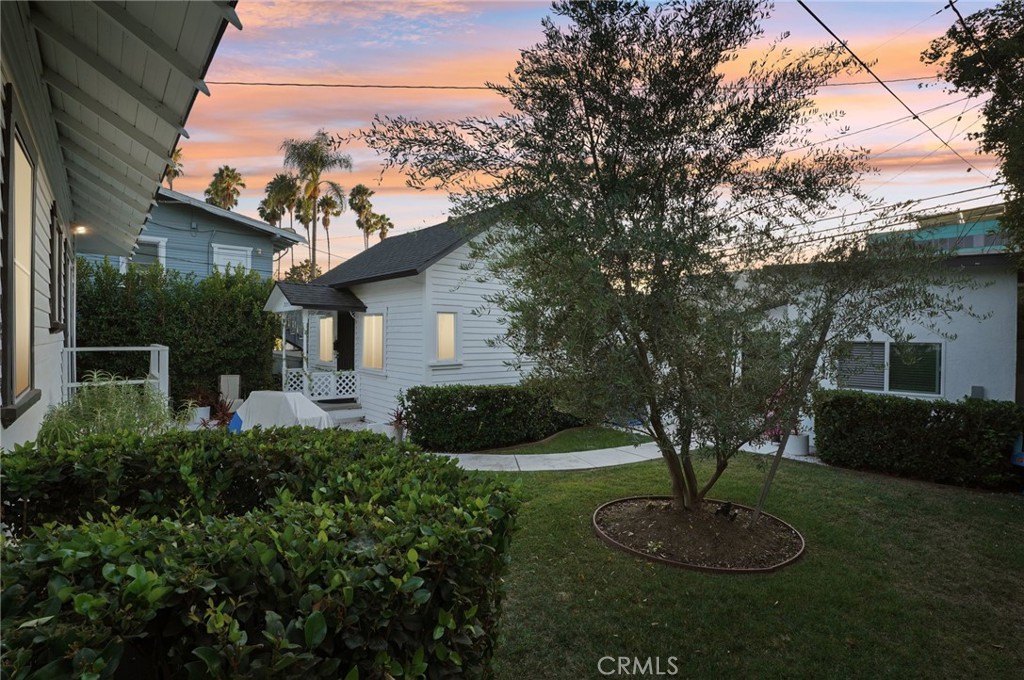7251 Painter Avenue, Unit 7255 Whittier, CA 90602 - Photo 2 of 56 a front view of a house with a garden and plants