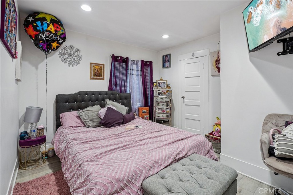 7251 Painter Avenue, Unit 7255 Whittier, CA 90602 - Photo 23 of 56 a bedroom with a bed a couch and a flat tv screen