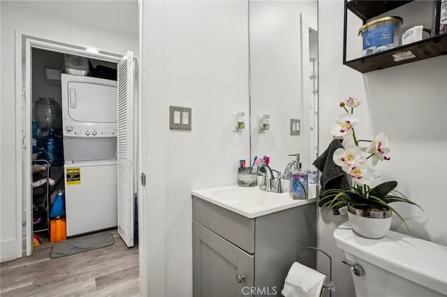 a bathroom with a granite countertop sink mirror vanity and toilet