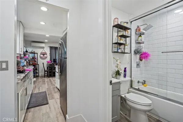 a bathroom with a granite countertop toilet a sink and a mirror