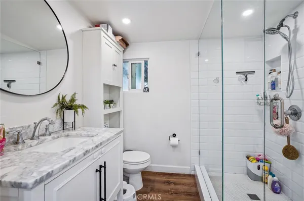 a bathroom with a sink toilet and shower