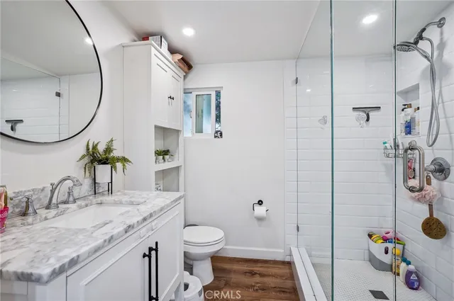 a bathroom with a sink toilet and shower