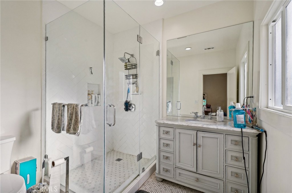 7251 Painter Avenue, Unit 7255 Whittier, CA 90602 - Photo 43 of 56 a bathroom with a double vanity sink mirror and shower