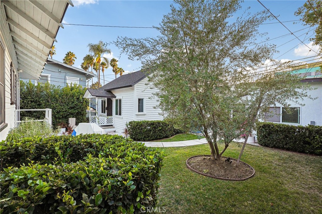 7251 Painter Avenue, Unit 7255 Whittier, CA 90602 - Photo 47 of 56 a front view of a house with a yard and potted plants