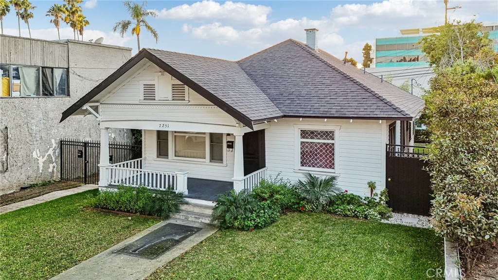 7251 Painter Avenue, Unit 7255 Whittier, CA 90602 - Photo 50 of 56 a front view of a house with a yard and porch