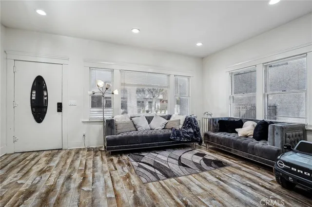 a living room with furniture a dining table a lamp and a chandelier
