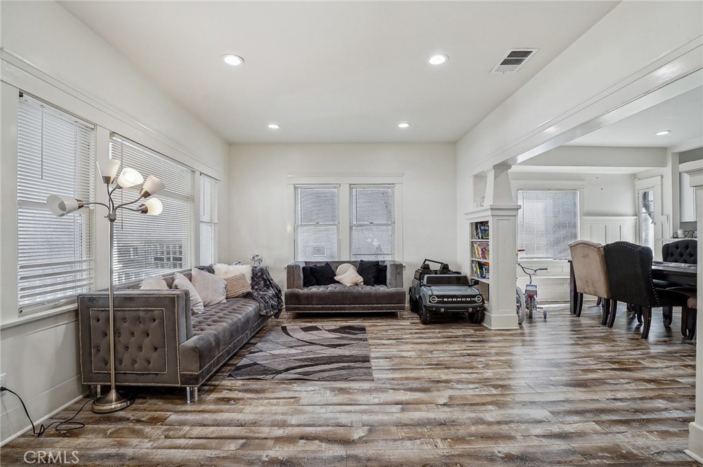 7251 Painter Avenue, Unit 7255 Whittier, CA 90602 - Photo 9 of 56 a living room with furniture and a wooden floor