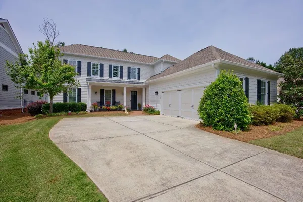 a view of house with yard and green space