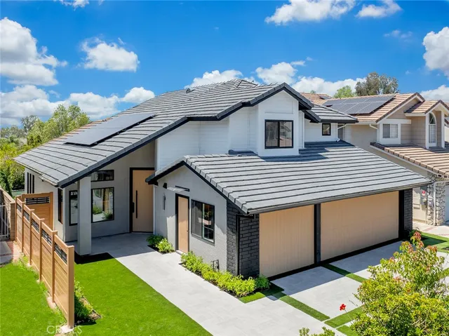 a aerial view of a house with a yard and potted plants