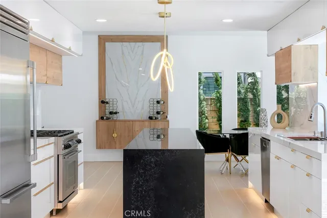 a room with a table chairs and a kitchen view