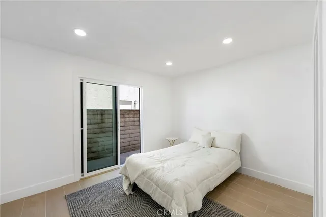 a spacious bedroom with a bed and a window