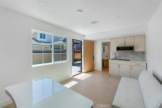 a large white kitchen with cabinets