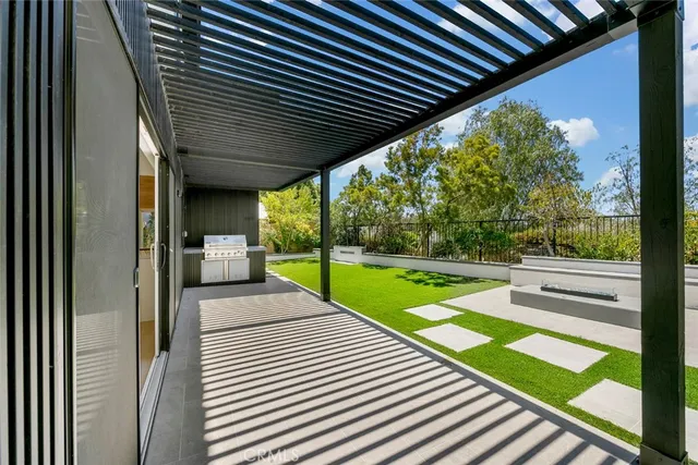 a view of a patio with wooden floor next to a yard