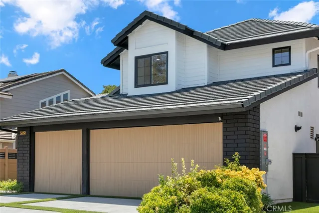 a view of a house with potted plants