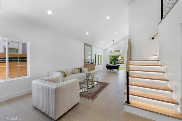 a living room with furniture and a entryway
