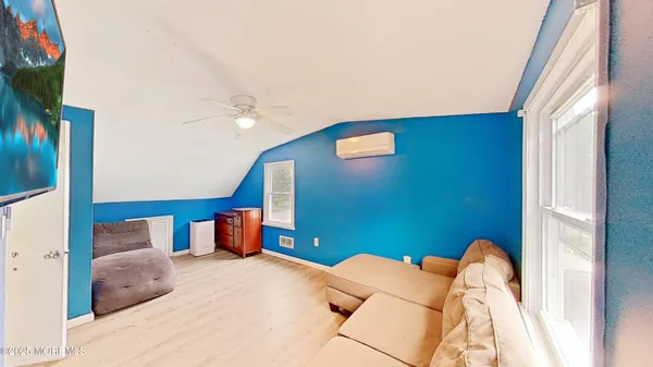 a bedroom with furniture and a potted plant