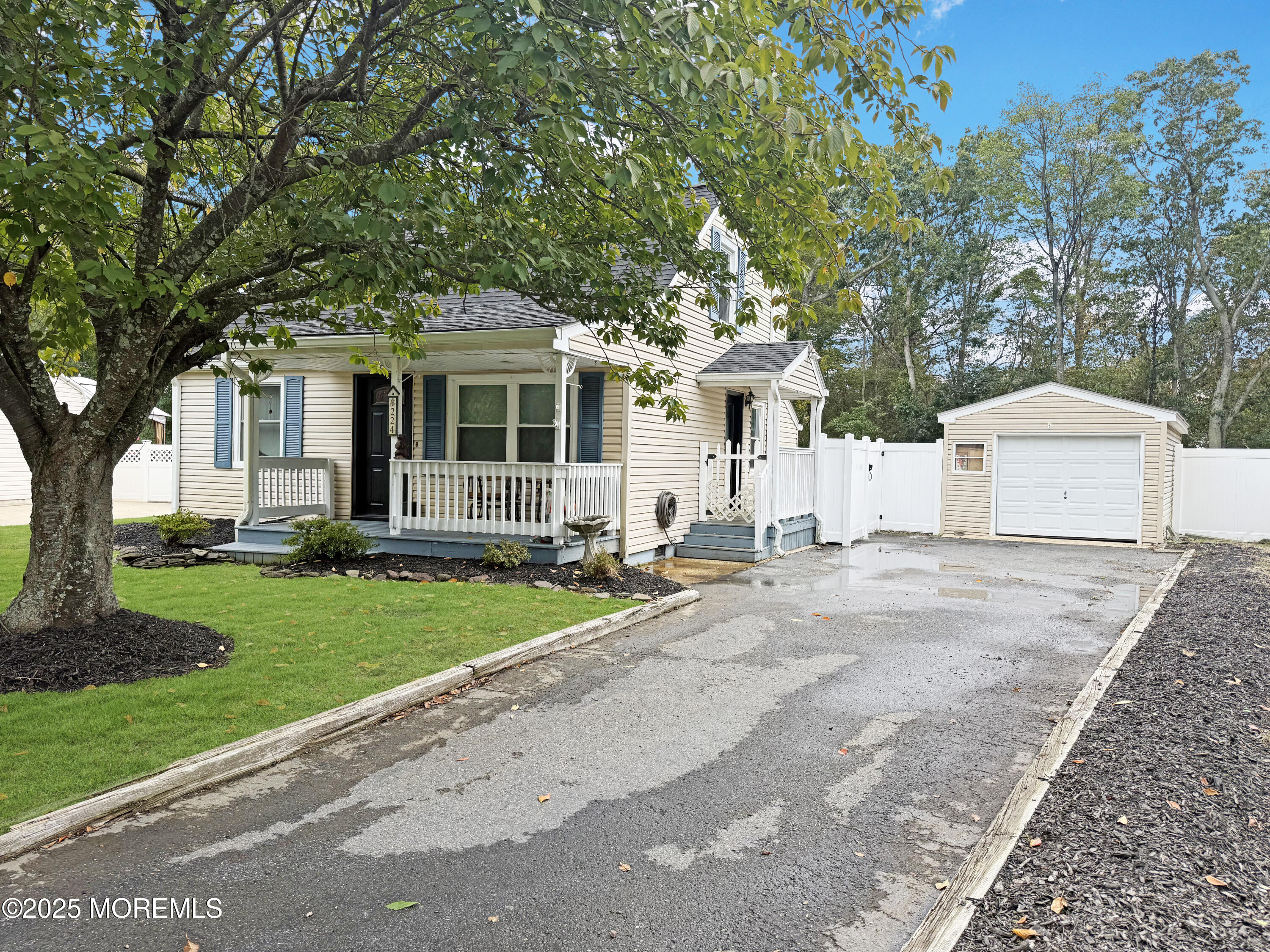 224 Sunset Lane Howell, NJ 07731 - Photo 17 of 23 a front view of a house with a garden and trees