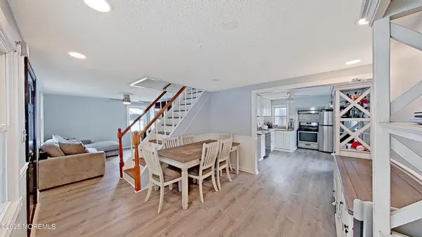 a view of a room with furniture and wooden floor